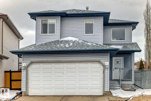 Two-story residence featuring light blue siding, an attached garage, and a covered front entry - 715 Hudson Place, Edmonton, AB - Outdoor With Exterior