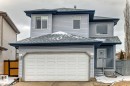 Two-story residence featuring light blue siding, an attached garage, and a covered front entry - 715 Hudson Place, Edmonton, AB  - Outdoor With Exterior 