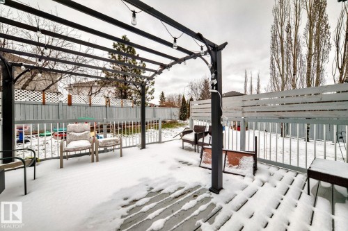 Deck featuring a dark metal pergola with string lighting, light wood-finish decking, and a perimeter railing - 715 Hudson Place, Edmonton, AB - Outdoor