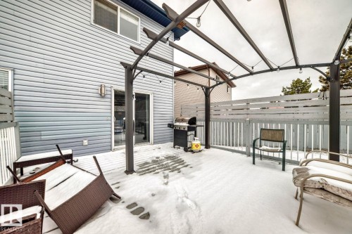 Hardscaped deck featuring a pergola with string lighting - 715 Hudson Place, Edmonton, AB - Outdoor With Exterior