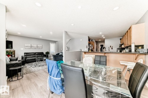 Open-concept floor plan featuring wood-finish flooring, recessed lighting, and light gray wall tones - 715 Hudson Place, Edmonton, AB - Indoor Photo Showing Other Room