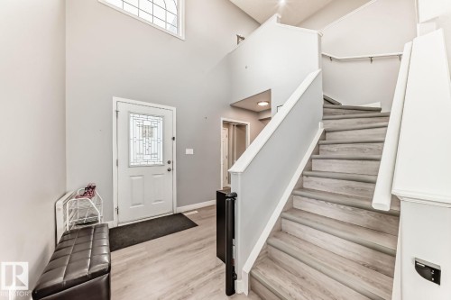 Bright entryway featuring a decorative glass front door, high ceilings, and light wood-finish flooring - 715 Hudson Place, Edmonton, AB - Indoor Photo Showing Other Room