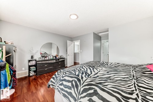 Bedroom featuring wood-finish flooring, light gray walls, and recessed ceiling lighting - 715 Hudson Place, Edmonton, AB - Indoor Photo Showing Bedroom