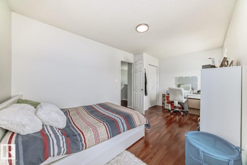 Bright room featuring wood-finish flooring, white walls, and a flush-mount ceiling light - 715 Hudson Place, Edmonton, AB - Indoor Photo Showing Bedroom