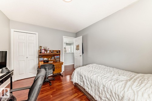 Bedroom featuring wood-finish flooring and light gray wall paint - 715 Hudson Place, Edmonton, AB - Indoor Photo Showing Bedroom