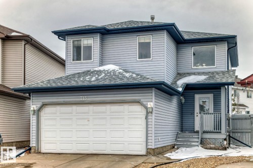 Two-story residence featuring light blue siding and a dark shingle roof - 715 Hudson Place, Edmonton, AB - Outdoor With Exterior