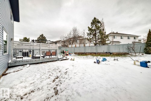 Expansive backyard featuring a wood deck with privacy screening and a perimeter fence - 715 Hudson Place, Edmonton, AB - Outdoor