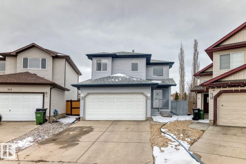 Two-story property featuring light gray siding, an attached double-car garage, and a concrete driveway - 715 Hudson Place, Edmonton, AB - Outdoor With Facade