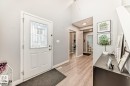 Entryway featuring a decorative glass panel door, light wood-finish flooring, and a mirrored closet door - 715 Hudson Place, Edmonton, AB  - Indoor Photo Showing Other Room 