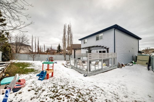 Rear exterior of a two-story residence featuring light-colored horizontal siding and dark trim - 715 Hudson Place, Edmonton, AB - Outdoor