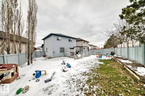 Expansive backyard featuring a multi-level wood deck, raised garden beds, and full perimeter fencing - 715 Hudson Place, Edmonton, AB - Outdoor