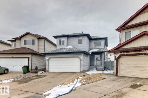 Two-story residence featuring light gray siding exterior and a light gray shingle roof - 715 Hudson Place, Edmonton, AB - Outdoor