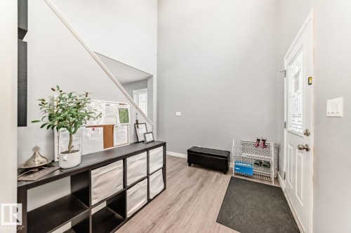 Entryway featuring a decorative front door with transom window, wood-finish flooring, and high ceilings - 715 Hudson Place, Edmonton, AB - Indoor Photo Showing Other Room
