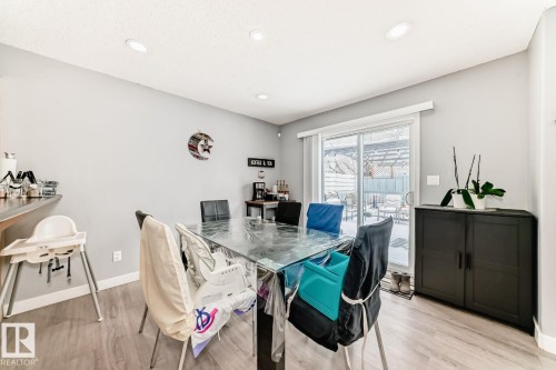 Dining area featuring wood-finish flooring, recessed lighting, and a sliding glass door leading to an outdoor space - 715 Hudson Place, Edmonton, AB - Indoor Photo Showing Dining Room