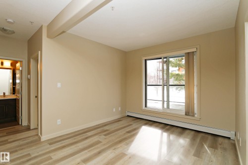 Bright interior space featuring light wood-finish flooring - 140 308 Ambleside Link Link Sw, Edmonton, AB - Indoor Photo Showing Other Room
