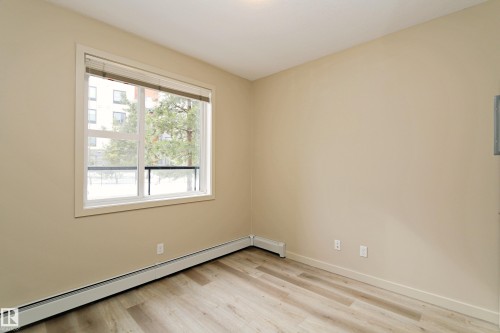 Neutral-toned walls complement the light wood-finish flooring - 140 308 Ambleside Link Link Sw, Edmonton, AB - Indoor Photo Showing Other Room