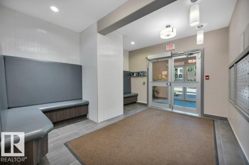 Entryway featuring double glass doors, recessed lighting, and built-in bench seating - 140 308 Ambleside Link Link Sw, Edmonton, AB - Indoor Photo Showing Other Room