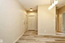 Entry area featuring wood-finish flooring and light-toned walls - 140 308 Ambleside Link Link Sw, Edmonton, AB  - Indoor Photo Showing Other Room 