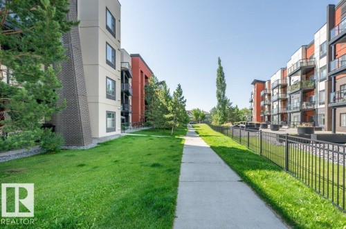 Contemporary apartment buildings featuring private balconies and a black metal fence - 140 308 Ambleside Link Link Sw, Edmonton, AB - Outdoor