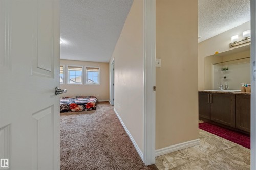 Expansive room featuring multiple windows, neutral wall tones, and textured carpeting - 2314 22 Avenue, Edmonton, AB - Indoor Photo Showing Other Room