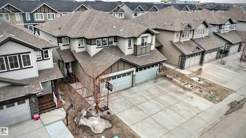 Two-story residence featuring light gray siding, dark gray trim, and a prominent front-facing double garage - 2314 22 Avenue, Edmonton, AB - Outdoor