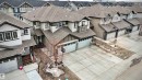 Two-story residence featuring light gray siding, dark gray trim, and a prominent front-facing double garage - 2314 22 Avenue, Edmonton, AB  - Outdoor 