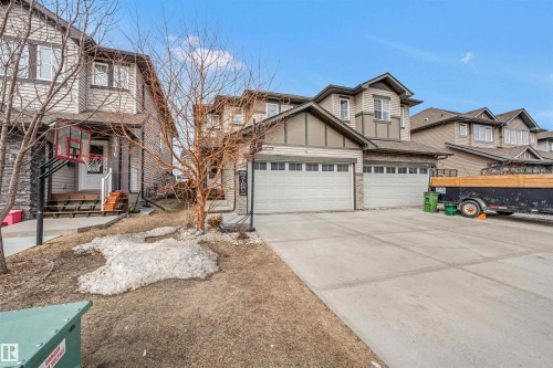 Two-story property featuring a double-wide concrete driveway and an attached two-car garage - 2314 22 Avenue, Edmonton, AB - Outdoor With Facade