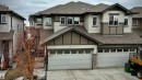 Two-story residence featuring a gray shingle roof, light-colored siding, and stacked stone accents - 2314 22 Avenue, Edmonton, AB  - Outdoor With Facade 