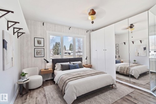 Wood-finish flooring throughout, complemented by a light wood-paneled accent wall - 13635 108 Avenue, Edmonton, AB - Indoor Photo Showing Bedroom