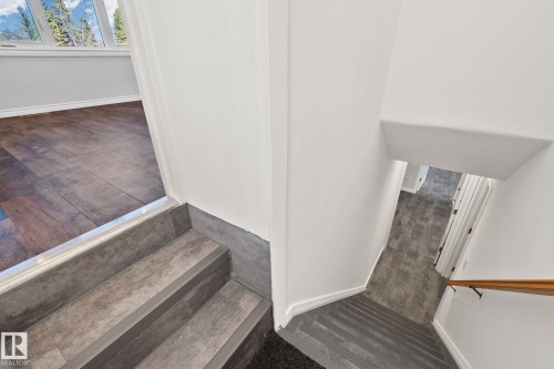 Split-level entry featuring wood-look flooring and a window with mountain scenery - 13635 108 Avenue, Edmonton, AB - Indoor Photo Showing Other Room
