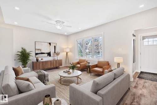 Spacious living area featuring wood-finish flooring, recessed lighting, and a ceiling fan - 13635 108 Avenue, Edmonton, AB - Indoor Photo Showing Living Room