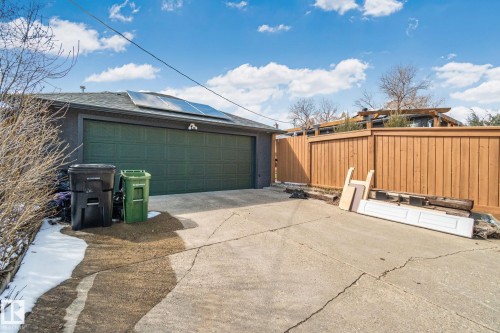 Detached garage with a paneled green door and solar panels on the roof - 13635 108 Avenue, Edmonton, AB - Outdoor