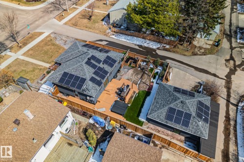 Property featuring a dark gray roof with multiple solar panel arrays - 13635 108 Avenue, Edmonton, AB - Outdoor