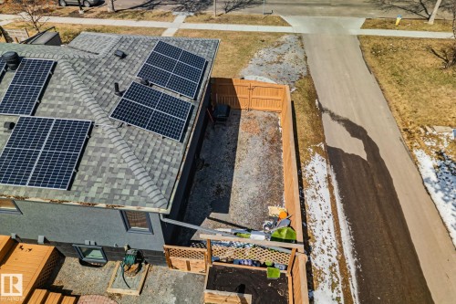 Asphalt shingle roof with multiple solar panel arrays - 13635 108 Avenue, Edmonton, AB - 