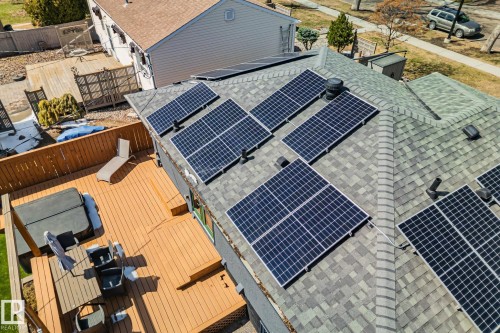 Asphalt shingle roof featuring multiple solar panel arrays - 13635 108 Avenue, Edmonton, AB - Outdoor