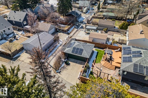 Rear exterior featuring a multi-level wood deck, artificial turf, and privacy fencing - 13635 108 Avenue, Edmonton, AB - Outdoor