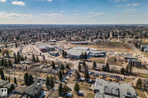 Aerial perspective showcasing a residential neighborhood with established trees, commercial development, and institutional buildings - 13635 108 Avenue, Edmonton, AB - Outdoor With View