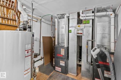 Dedicated utility space featuring a large water heater, multiple Goodman HVAC units, extensive ductwork, and PEX plumbing - 13635 108 Avenue, Edmonton, AB - Indoor Photo Showing Basement