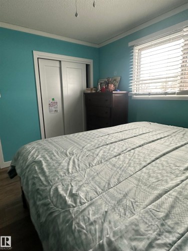 This room features light blue walls, a window with blinds, and white trim - 5420 40 Avenue, Wetaskiwin, AB - Indoor Photo Showing Bedroom