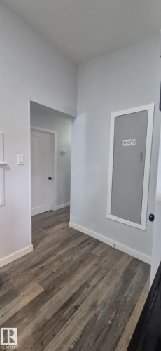 Hallway with wood-style flooring and a built-in pantry - 5420 40 Avenue, Wetaskiwin, AB - Indoor Photo Showing Other Room