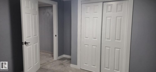 The property features grey walls, white trim, and light-colored carpet - 5420 40 Avenue, Wetaskiwin, AB - Indoor Photo Showing Other Room