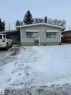 The property features light blue siding, a covered carport, and a gravel driveway - 5420 40 Avenue, Wetaskiwin, AB  - Outdoor 