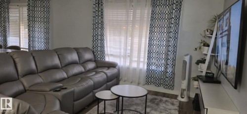Living area featuring light colored walls and windows with blinds - 5420 40 Avenue, Wetaskiwin, AB - Indoor Photo Showing Living Room