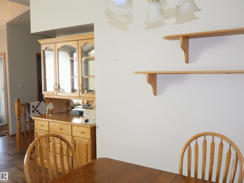 Built-in wood-finish hutch with glass-front cabinetry and drawer storage - 5802 52 Avenue, Barrhead, AB - Indoor
