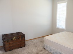 Room with light gray walls, white trim, and light brown baseboards - 