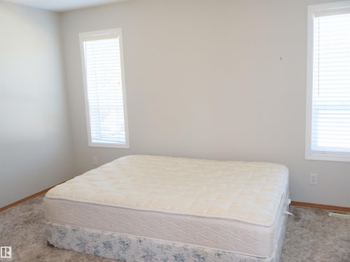 Neutral-toned walls complement the light-colored carpet flooring - 5802 52 Avenue, Barrhead, AB - Indoor Photo Showing Bedroom