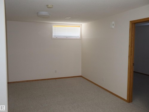 Neutral-toned carpeting and light-colored walls define this room - 5802 52 Avenue, Barrhead, AB - Indoor Photo Showing Other Room