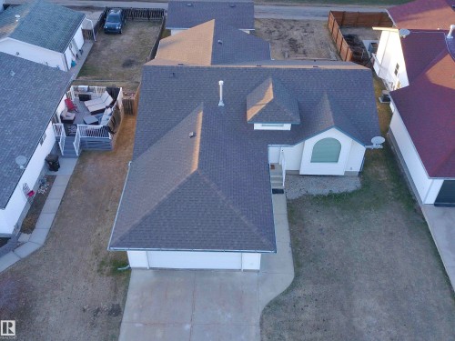 Single-story residence featuring an arched window, a two-car garage, and a charcoal shingle roof - 5802 52 Avenue, Barrhead, AB - Outdoor
