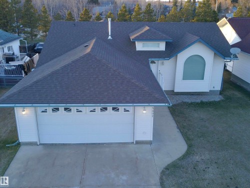 Contemporary single-story residence with a multi-pitched dark shingle roof - 5802 52 Avenue, Barrhead, AB - Outdoor