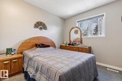 Room featuring a single white-framed window, textured ceiling, and neutral wall tones - 
